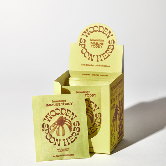 Yellow packaging of Wooden Spoon Herbs Immune Toddy on a white background