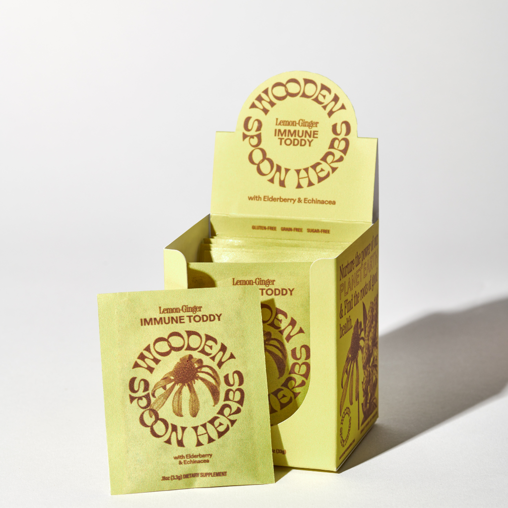Yellow packaging of Wooden Spoon Herbs Immune Toddy on a white background