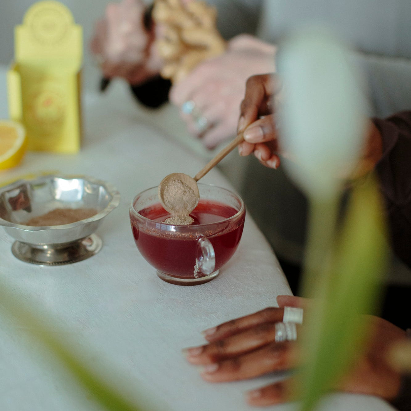 WSH herbal being poured into a glass cup.