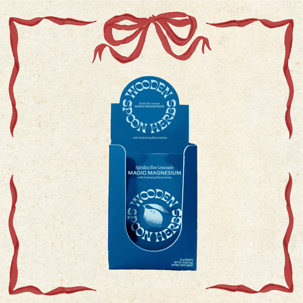 Blue packaging of Wooden Spoon Herbs Magic Magnesium on a beige background with decorative red border