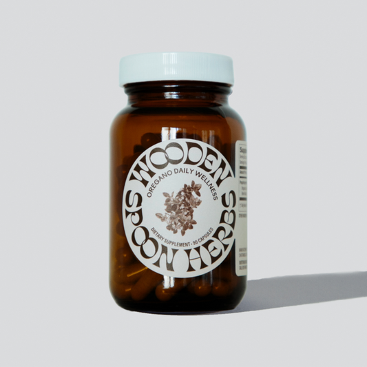 Brown glass bottle with white label on a light gray background