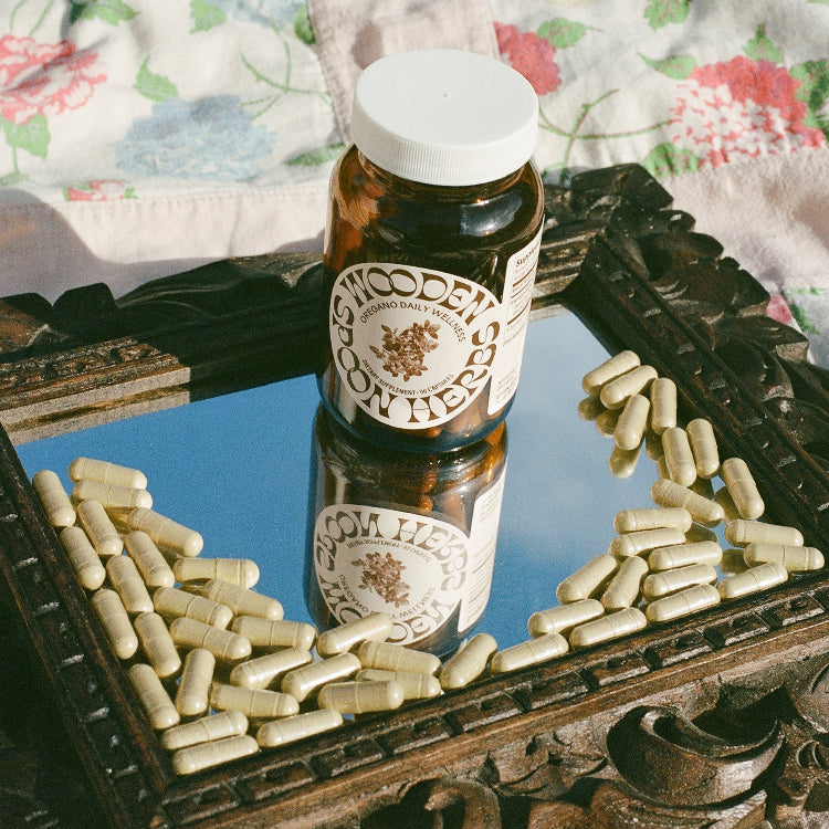 Oregano Daily Wellness Support Capsules on mirror decor