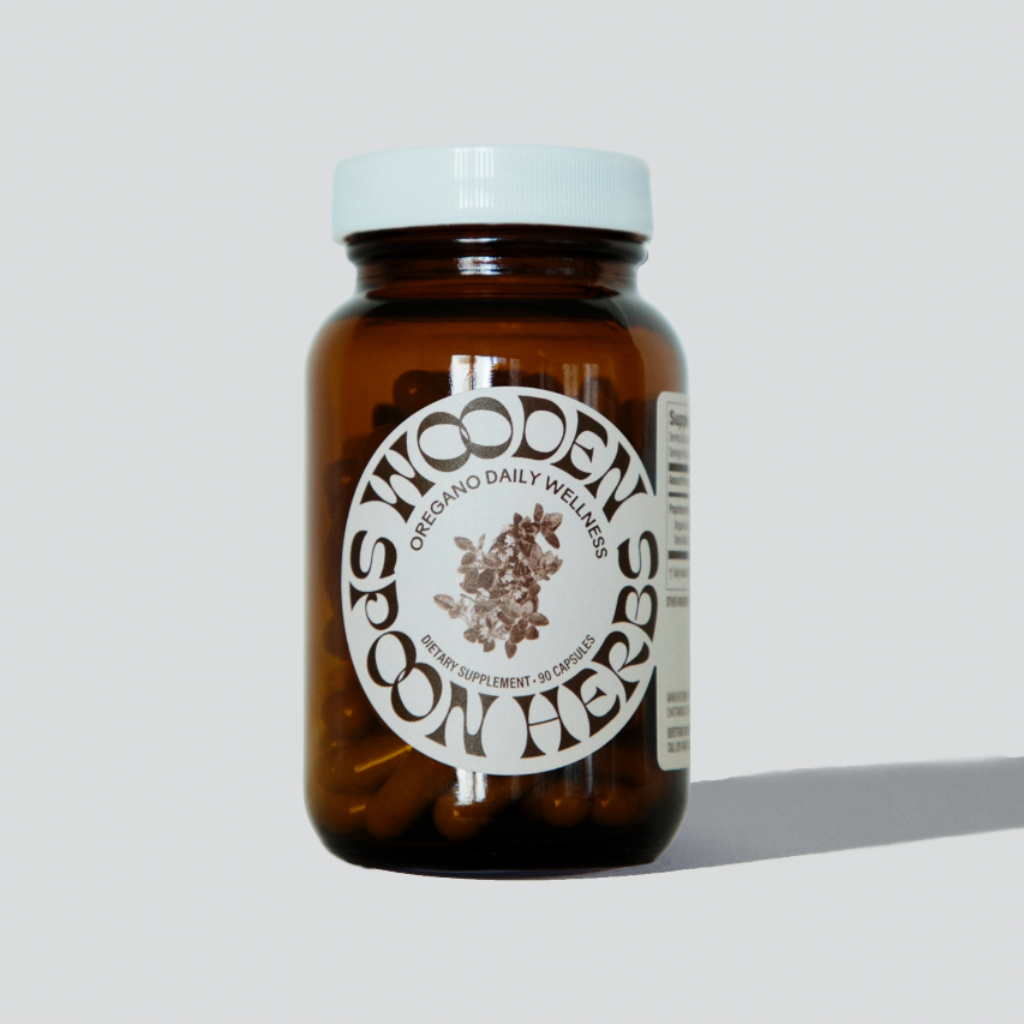 Brown glass bottle with white label on a light gray background