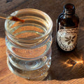 Tranquility Tonic near a glass of water