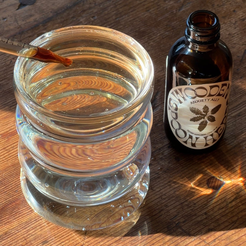 Tranquility Tonic near a glass of water