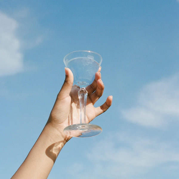 A clear glass toward a blue sky, evoking calm and clarity